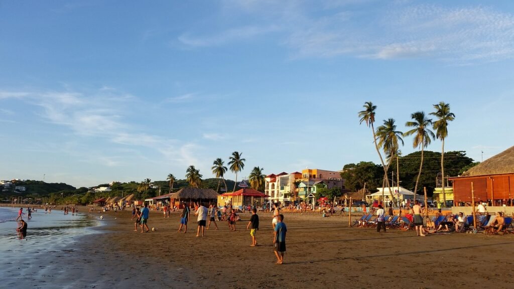 Beach with palm trees, restaurants, ranchos and beachgoers