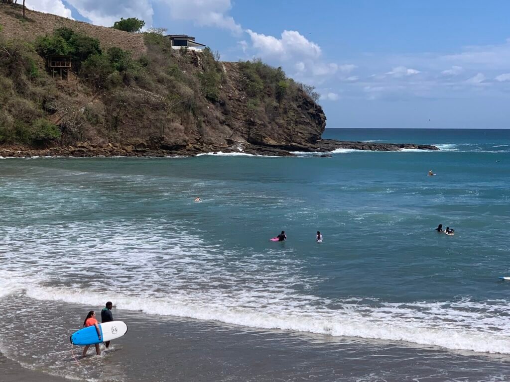 View of beach and ocean with surfers